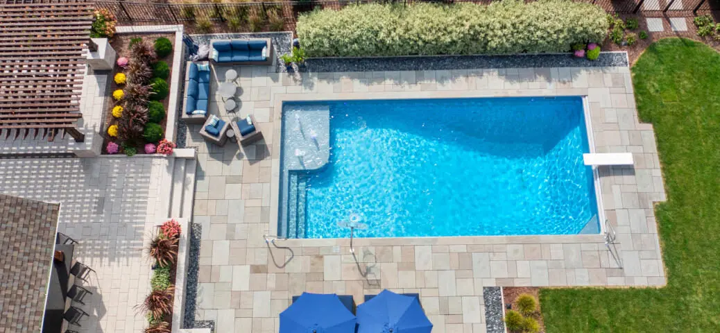 Overhead of inground swimming pool with bubblers and diving board.