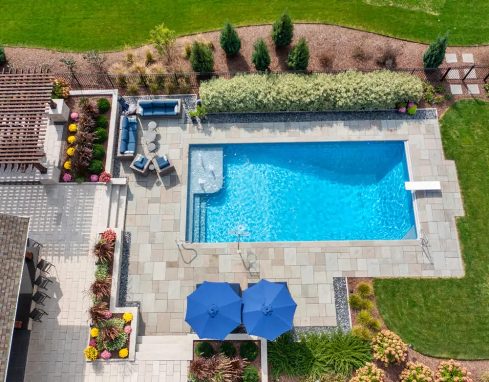 Overhead of inground swimming pool with bubblers and diving board.