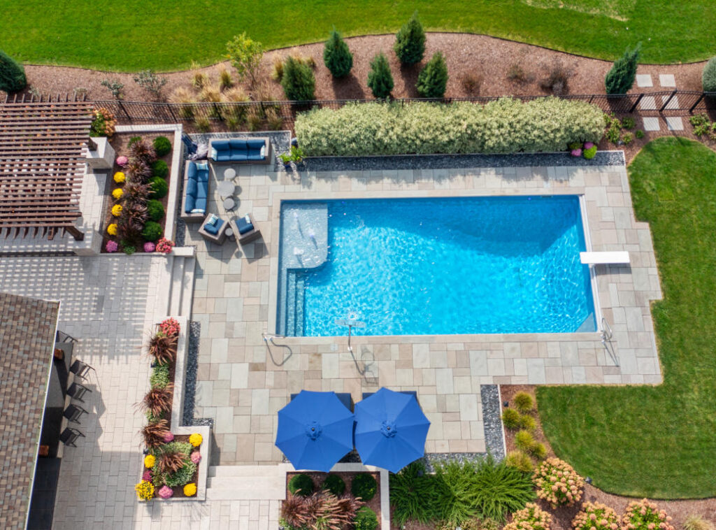 Overhead of inground swimming pool with bubblers and diving board.